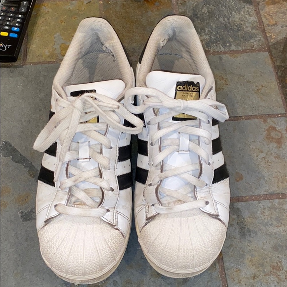 Black and white adidas superstars